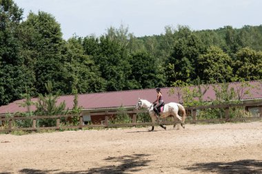 Harkov, Ukrayna. 4 Temmuz 2020. Coronavirus sırasında karantinayı zayıflattıktan sonra kız en sevdiği spor olan ata binmeye başlar..