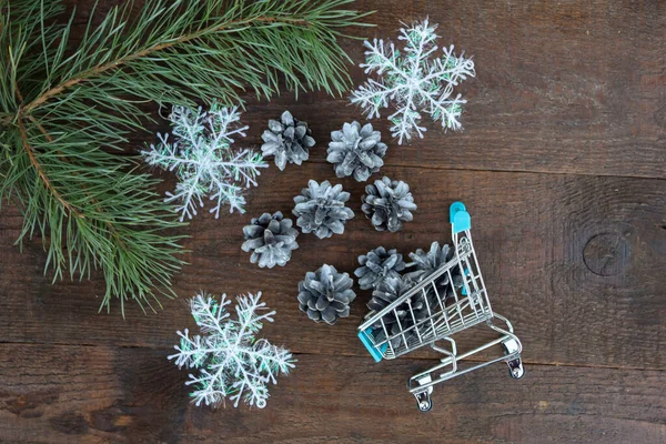 Pine Branch Lies Wooden Background Silver Cones Spilled Supermarket Cart — Stock Photo, Image