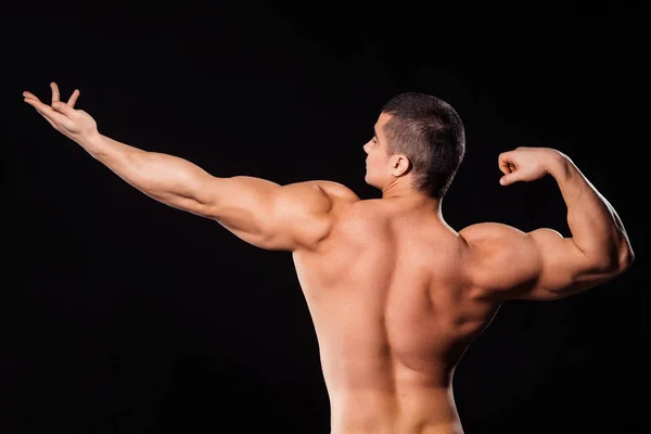 Bodybuilder in archer pose. — Stockfoto