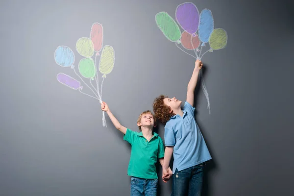 Two happy boys with balloons