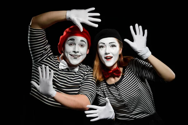 Smiling mimes in striped shirts