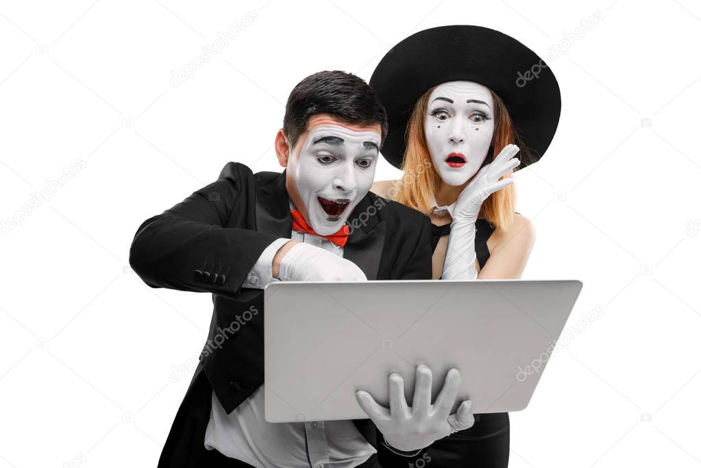 Mimes using a laptop