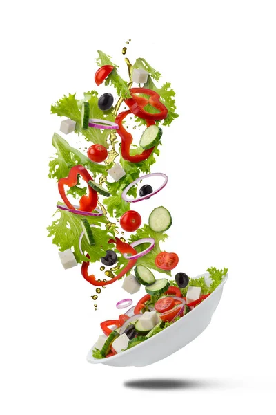 Flying Greek salad on white Stock Picture