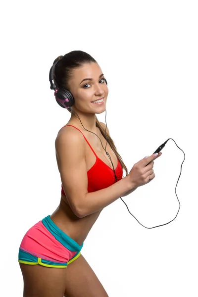 Fitness girl listening to music — Stock Photo, Image