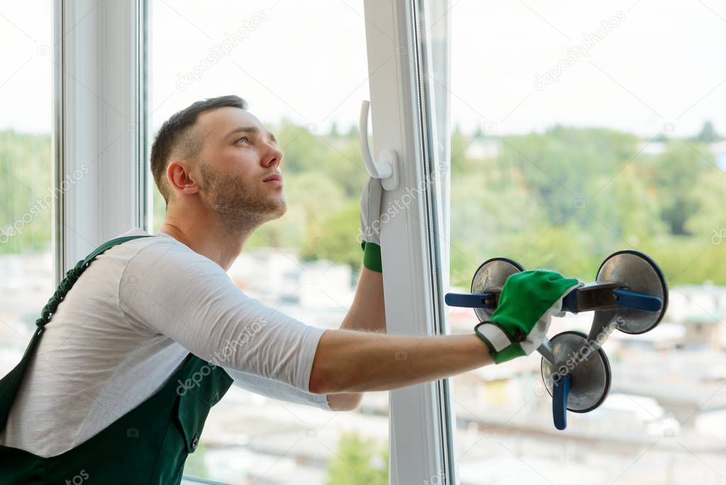 Handyman is repairing a window