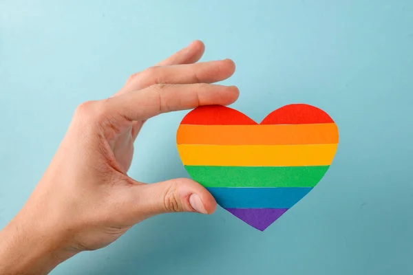 Gay holding a rainbow heart