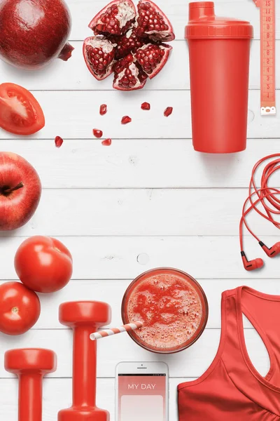 Red food, sport equipment and phone