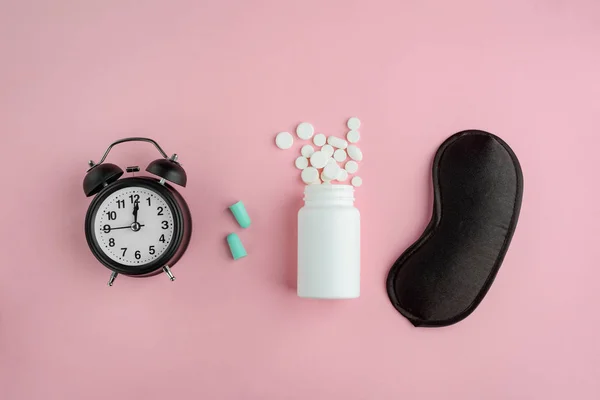 Table clock, earplugs, sleeping pills