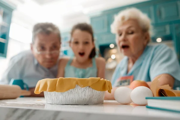 Surprised family looking at pie