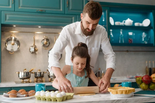 Father teaches daughter to cook