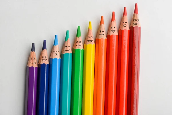 Colored pencils with funny smiles — Stock Photo, Image