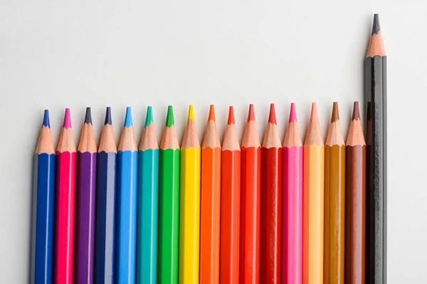 Colored pencils against black — Stock Photo, Image