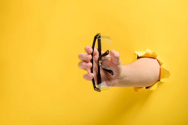 Mão dando óculos de segurança — Fotografia de Stock