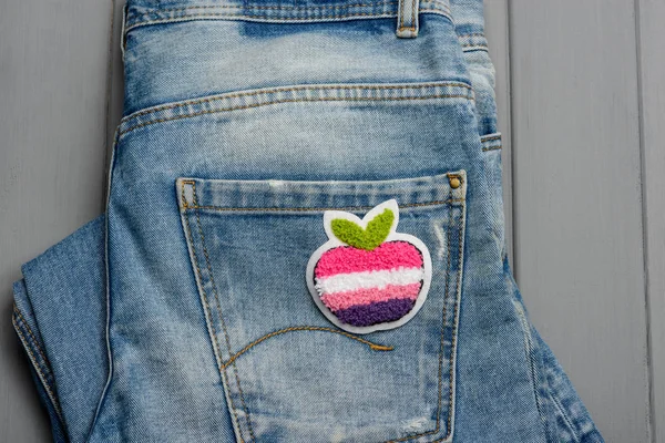 Apple fabric patch on denim — Stock Photo, Image