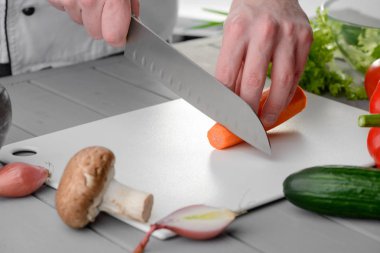 Chef cook cutting a carrot clipart