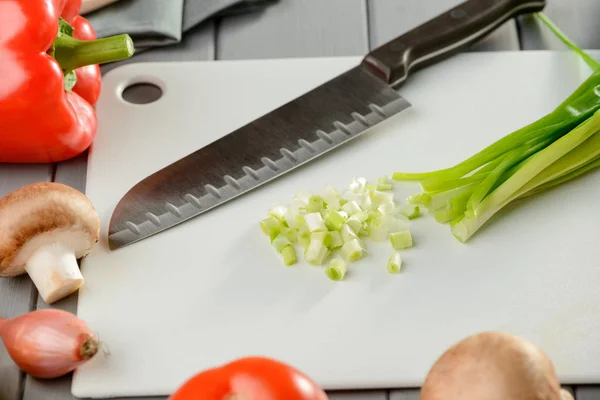 Sliced spring onion and knife
