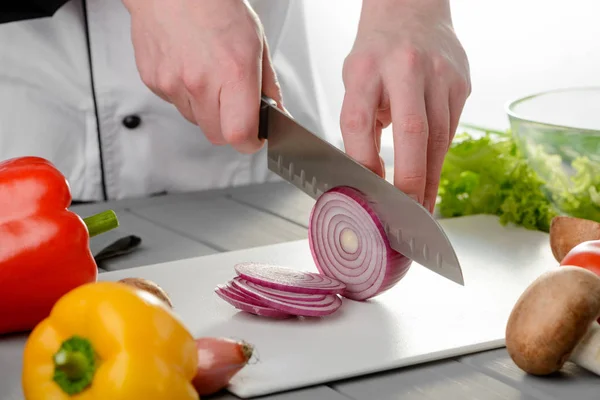 Chef cortando uma cebola vermelha — Fotografia de Stock