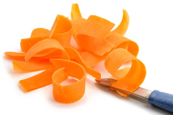 Carrot shavings and peeler knife — Stock Photo, Image