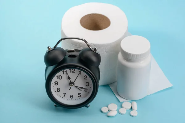 Clock, toilet paper and pills