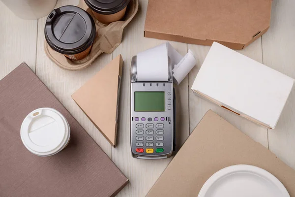 Payment terminal between paper boxes