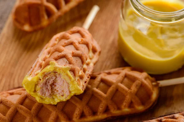 Appetizing corn dogs with mustard