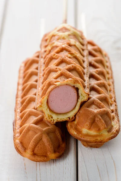 Waffle corn dogs on table