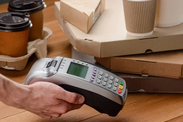 Cashier holding a POS terminal