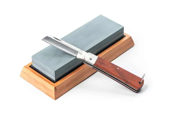 Jackknife and a whetstone isolated on white background — Stock Photo, Image
