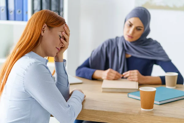 Confused woman failed an interview and making a facepalm