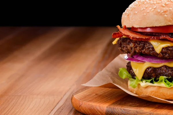 Close-up op dubbele cheeseburger op houten achtergrond — Stockfoto