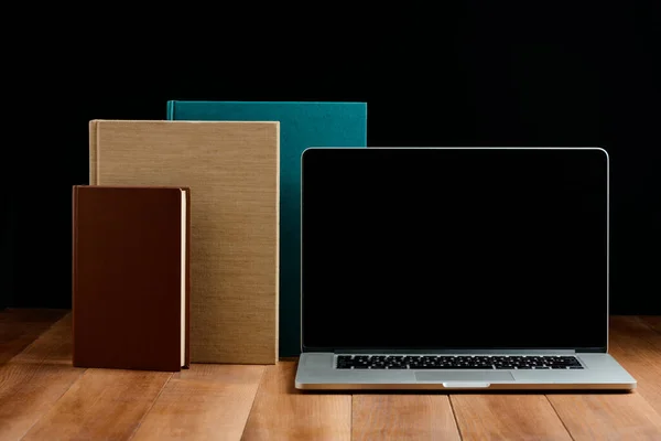 Hardcover books and laptop on wooden desktop — Stock Photo, Image