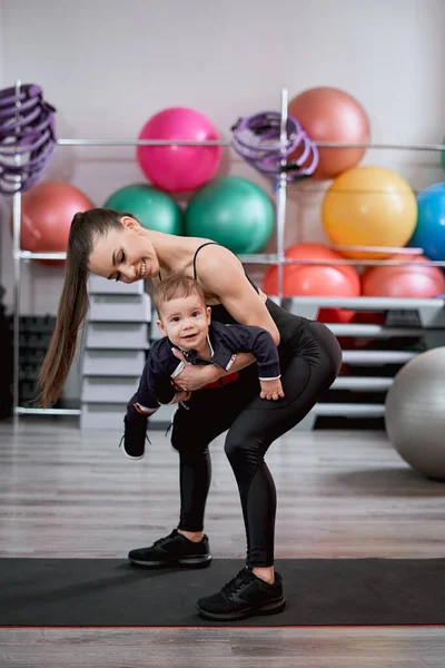 Mulher e seu pequeno filho em um ginásio — Fotografia de Stock
