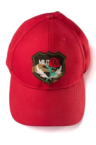 Gorra roja con parche bordado rosa militar sobre fondo blanco — Foto de Stock