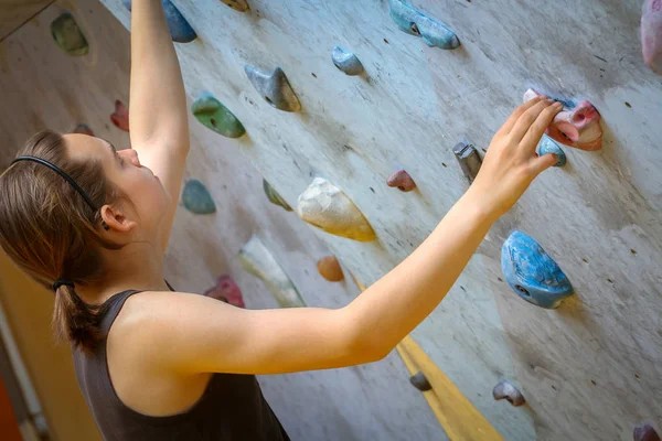 Teenage Boy Training Climbing On Indoor Climbing Wall