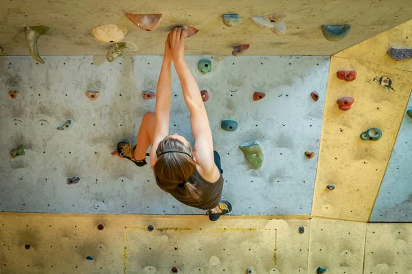 Teenage Boy Training Climbing On Indoor Climbing Wall