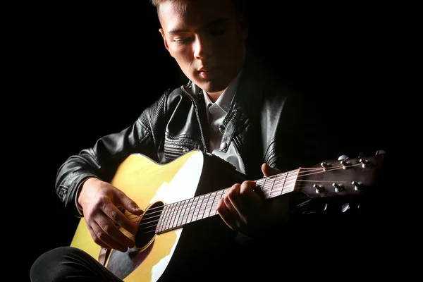 Young men playing the guitar