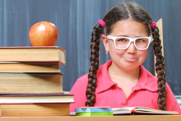 Happy school girl in front of the blackboard — Stock Photo, Image