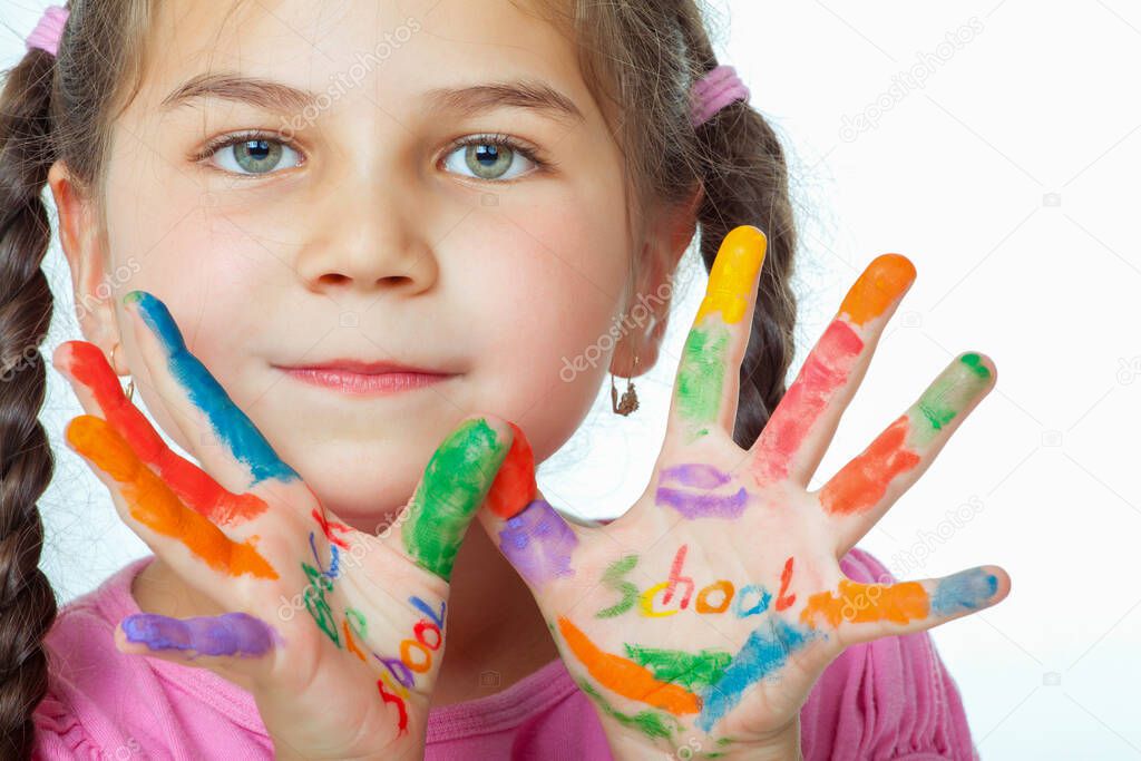 Beautiful little girl with her hands full of paint