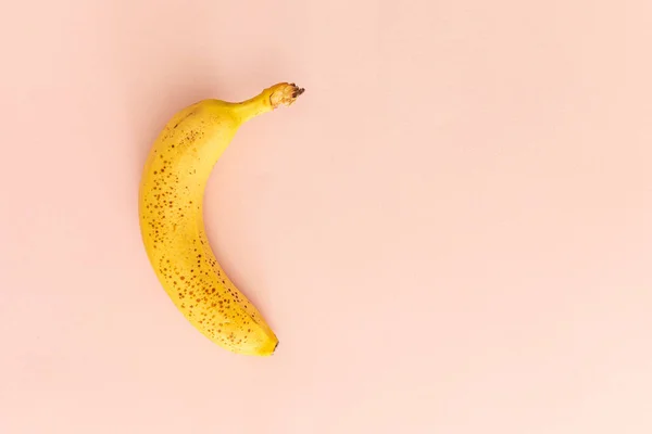 A Yellow Banana Isolated over Pink Background