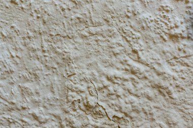 Duvarın dokusu pastel renkler ve çatlaklarla kaplı. Soyut arkaplan