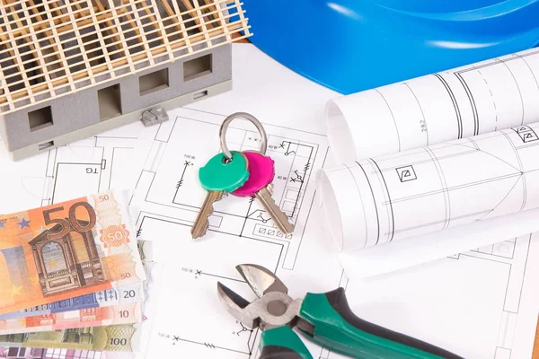 Currencies euro, home keys, electrical drawings or diagrams for engineer jobs and house under construction, concept of building home cost