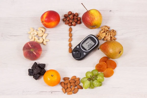 Glucometer with ripe fruits in shape of clock, time for healthy food for diabetics containing vitamins, dietary fiber and natural minerals