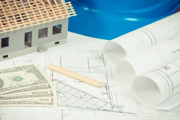 Currencies dollar, electrical diagrams, accessories for engineer jobs and house under construction, concept of building home cost