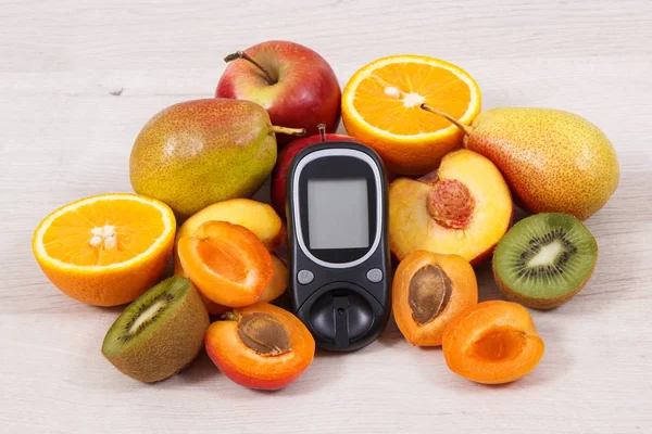 Glucose meter for checking sugar level and fresh nutritious fruits as healthy dessert for diabetics