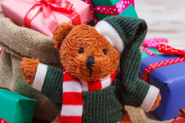 Teddy bear and wrapped colorful gifts for Christmas, birthday, valentines or other celebration