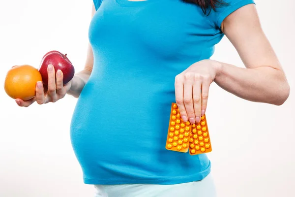 Pregnant Woman Holding Fresh Ripe Fruits Medical Tablets Supplements Choice — Stock fotografie