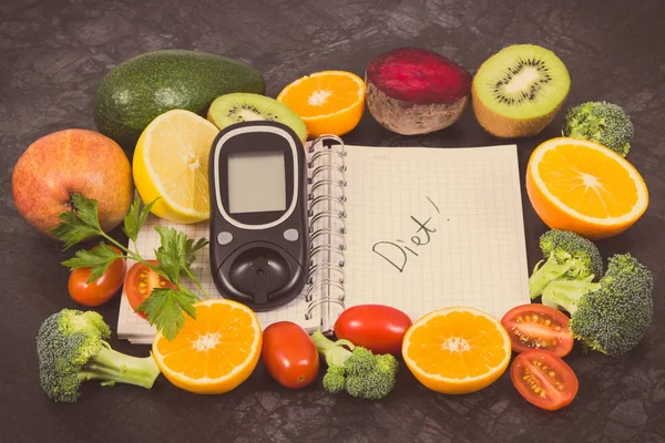 Glucose meter for checking sugar level, notepad and fresh ripe fruits with vegetables containing natural vitamins. Diabetes, slimming and diet concept
