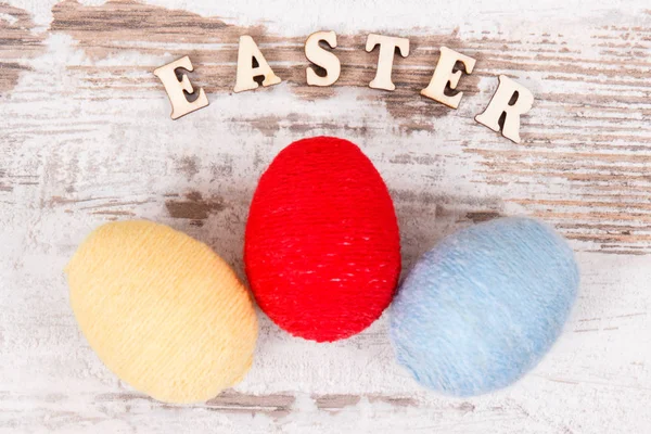 Inscription Easter Colorful Eggs Wrapped Woolen String Old Rustic Board — Stock Photo, Image