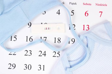 Hamilelik testi ve bebek için bekliyor takvimde yeni doğan için giyim