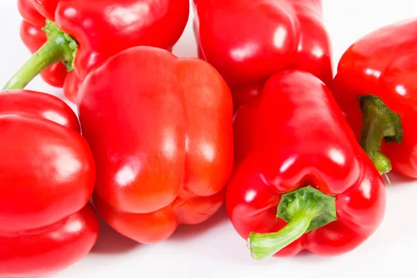 Fresh red peppers lying on white background, healthy nutrition concept — Stock Photo, Image